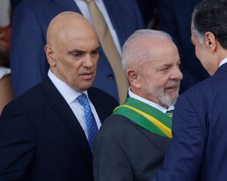 Brazil’s supreme court Judge Alexandre de Moraes, left, beside president Luiz Inacio Lula da Silva, center, last year.