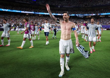 Lionel Messi celebrates with his top off