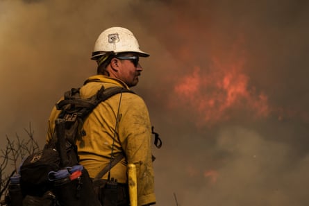 A firefighter watches as the Alisal fire burns through the coastal mountains near Goleta, California, on Wednesday.