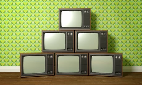 Old televisions stacked as a pyramid.