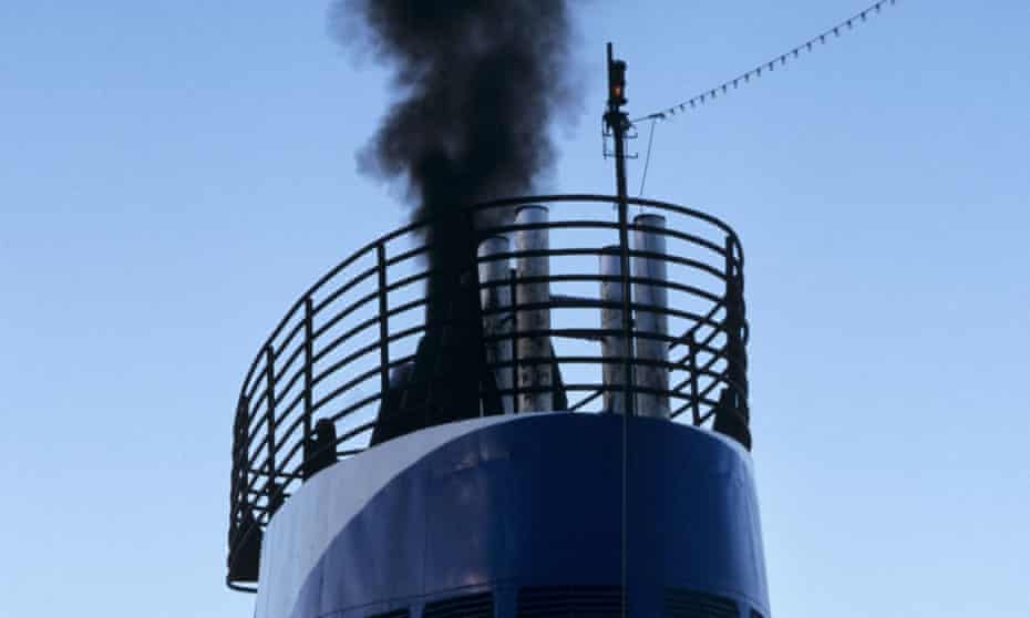 Black smoke pours from a ship’s funnel