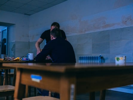 People sitting at wooden tables in the canteen