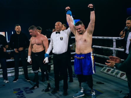 Khrebet having his arm raised in the air by the judge