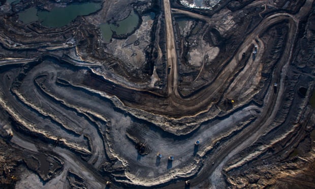 Trucks and machinery along routes within the Suncore oil Sands site near Fort McMurray in Northern Alberta, Canada