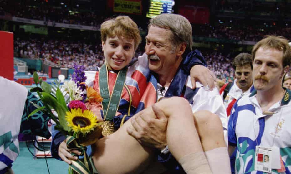 Coach Bela Karolyi carries an injured Kerri Strug of the United States after she received her gold medal in the Womens Team Gymnastics competition at the 1996 Olympic Games.