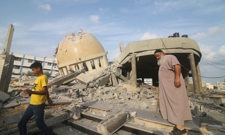 Palestinians inspect the ruins of a building destroyed in Israeli airstrikes in Khan Yunis in the Gaza Strip on Sunday.