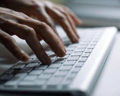 Hands typing on the keyboard in the office.