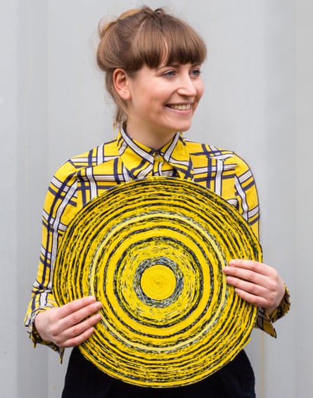 Simone Post with a round yellow rug made from trainers.