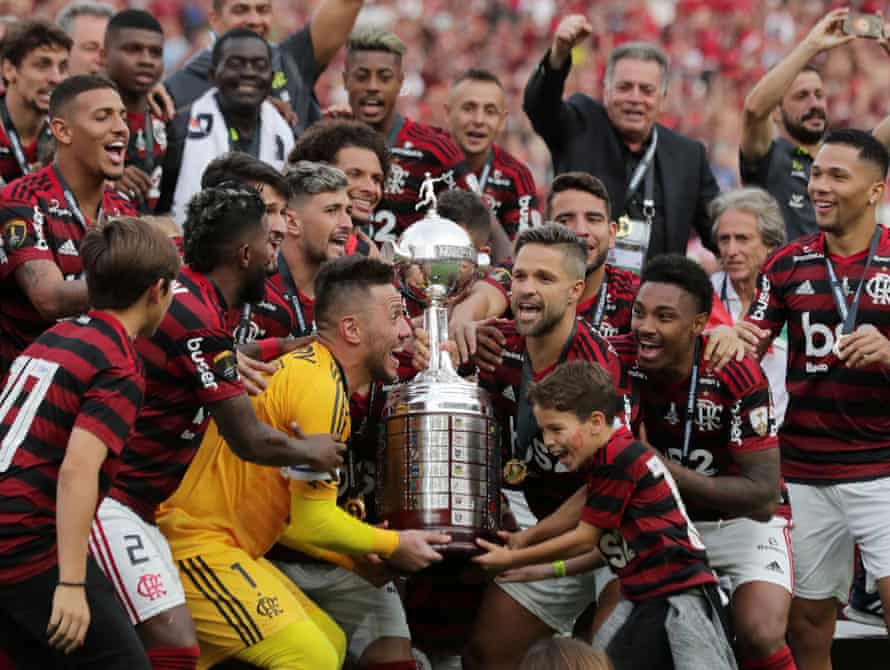 Flamengo’s Diego Alves and Diego lift the trophy with teammates as they celebrate after winning the Copa Libertadores final.