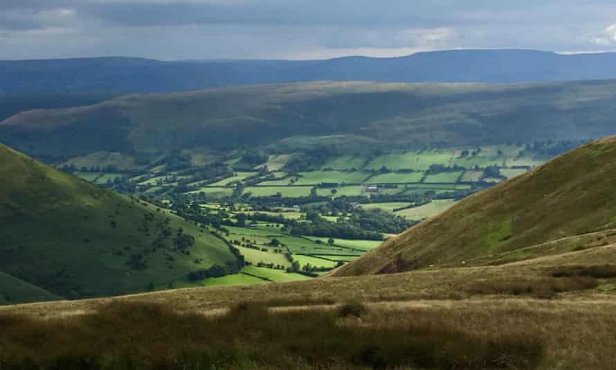 A Black Mountains view of a pastoral valley and brooding hills.