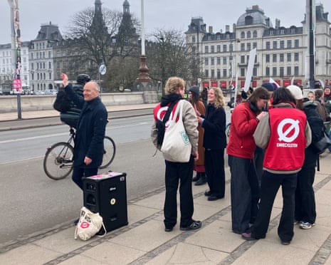 The Red-Green Alliance politician Pelle Dragsted high fives and waves at passing cyclists as he campaigns on the election day in Copenhagen, Denmark.