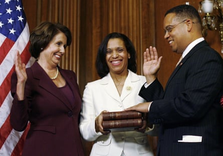 Keith Ellison takes his oath of office by swearing on a Qur’an with the speaker of the House, Nancy Pelosi, left, and his wife, Kim, center, in 2007.