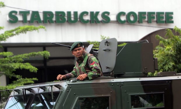 An Indonesian soldier on guard in an armoured vehicle after a bomb blast in front of a shopping mall in Jakarta on Thursday.
