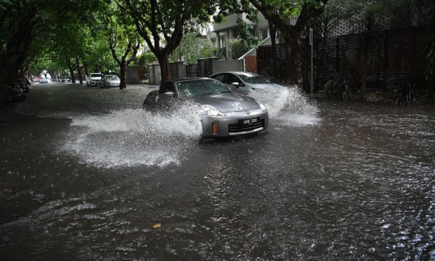 Wet weather: a car drives through flood water in Melbourne 