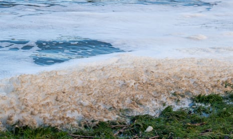 Sewage foam on the river Thames by Marlow Weir in Buckinghamshire. 