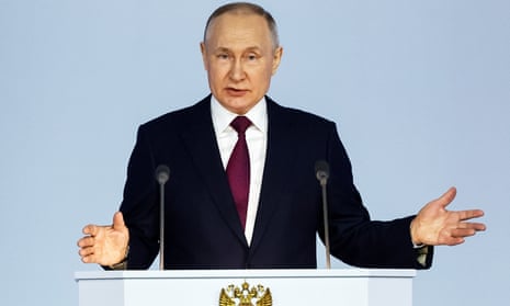 Vladimir Putin gestures as he gives his annual state of the nation address in Moscow on Tuesday
