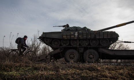 A resident rides by a broken Ukrainian tank near the  city of Bakhmut. Germany has declined to take a decision on supplying Kyiv with its Leopard 2 tanks.