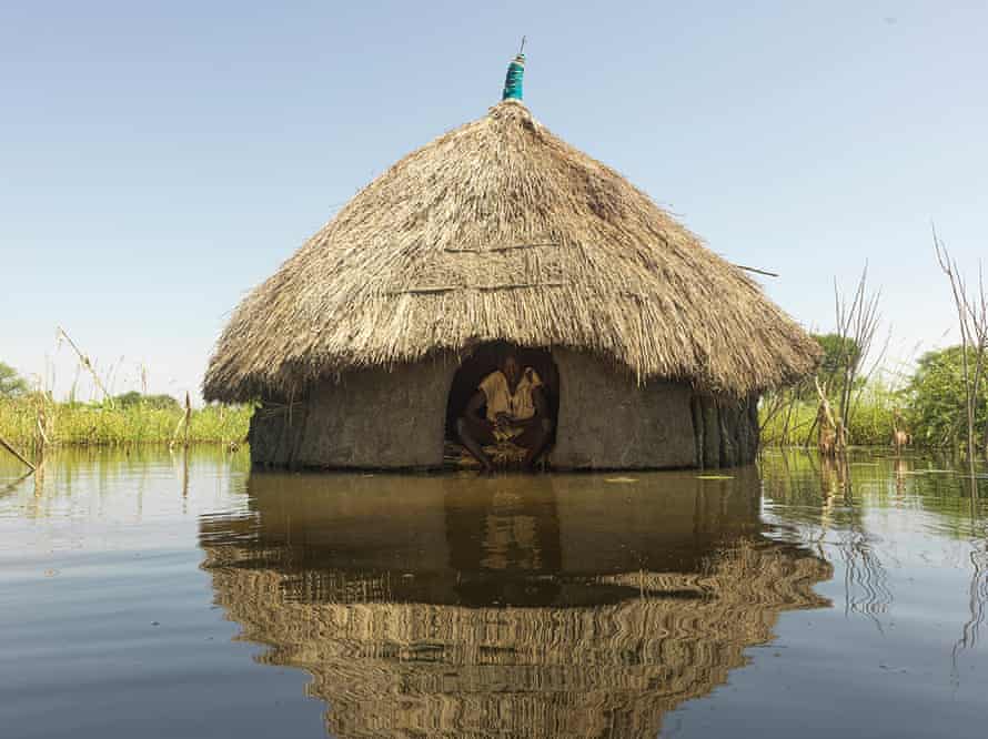 Peter Kak inside his flooded home