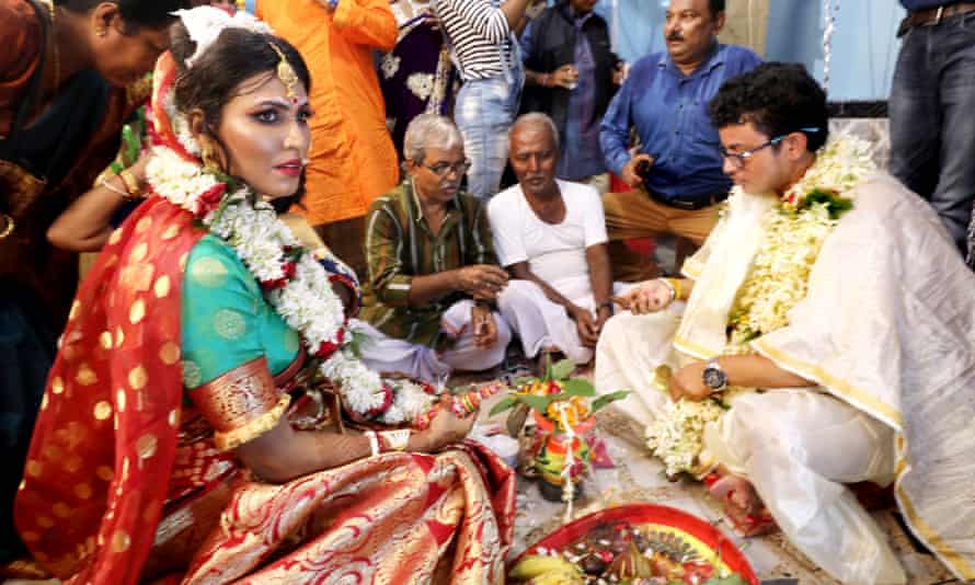 Tista Das (L) and groom Dipan Chakrabarty (R) perform a wedding ritual during a ceremony in Kolkata, India.