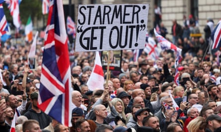 A demonstrator holds an anti-Keir Starmer placard at a march in London