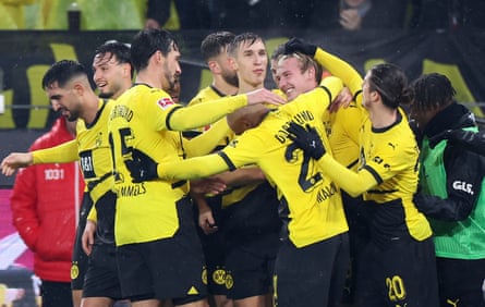 Julian Brandt celebrates with Dortmund teammates after scoring against Mainz.
