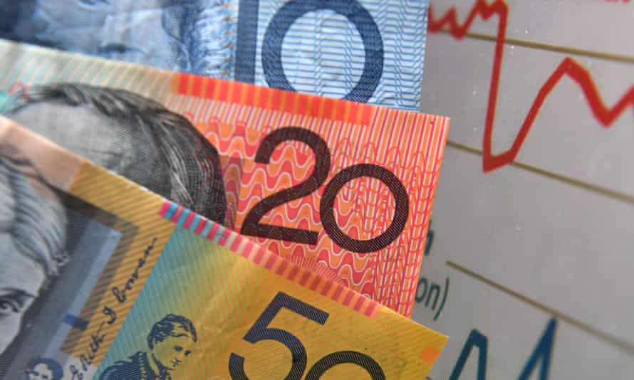 Australian currency is seen next to a wages graph in Brisbane, February 21, 2018.