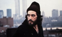 A man in a beanie in front of a city skyline.