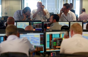 Traders from BGC, a global brokerage company in Canary Wharf, London’s financial centre, react during trading