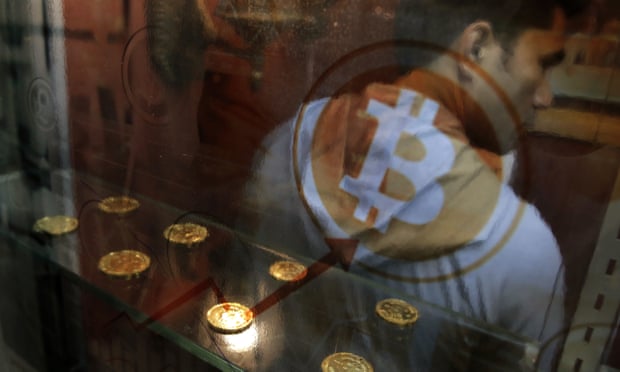 A man uses a bitcoin ATM in Hong Kong. 
