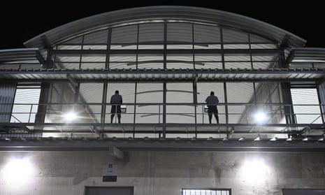 Government prison security officers stand guard inside a prison intended to house 40,000 alleged gang members, in a secluded rural area in a valley near Tecoluca, on 2 February.