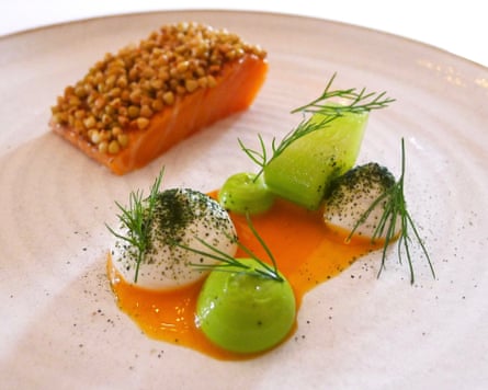A beautifully presented plate of food including salmon, dill and cucumber.