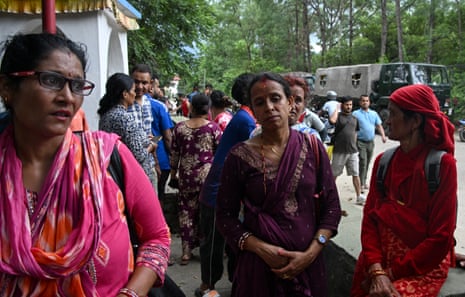 Rescued flood affected people wait outside an army camp in Nepal’s Nuwakot district on 26 August 2026.