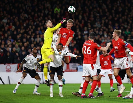 Manchester United's keeper David de Gea punches clear whilst being put under pressure by Nottingham Forest's Sam Sturridge.