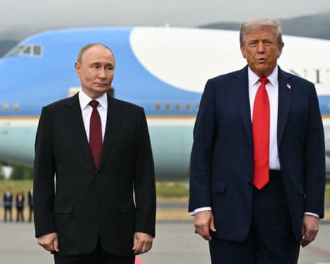 Donald Trump and Russian President Vladimir Putin pose on a podium on the tarmac after arrival at Joint Base Elmendorf-Richardson in Anchorage, Alaska.