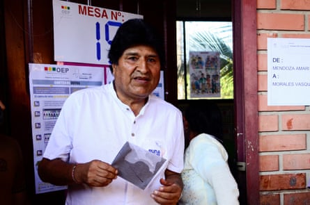 a man in a white shirt holds a piece of paper