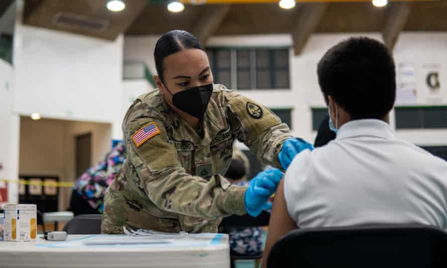 A vaccine is administered at the UOG Fieldhouse Vaccination centre, Guam. The island has a vaccination rate of nearly 90% of all eligible people.