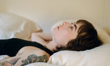 claire rousay in profile, lying on a bed