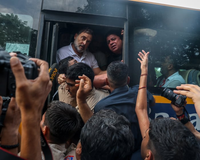 Rahul Gandhi detained and pulled on to bus after calling for PM Modi to resign – video