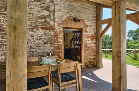 A table outside an old cottage under a veranda