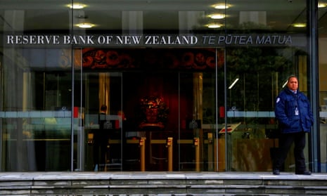 A security guard stands outside the main entrance to the Reserve Bank of New Zealand in central Wellington