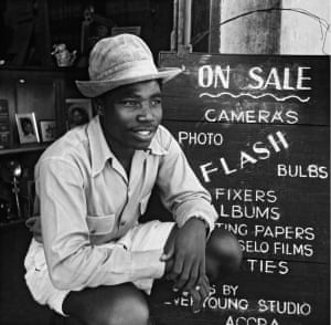 Alfred Quarshie by the advertising board of the Ever Young Studio, c. 1955