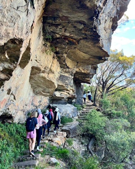 A group of hikers climbing a set of stone steps in the Blue Mountains, New South Wales.