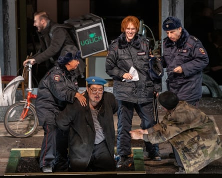 Opera singers dressed a Russian police hold down a man wearing a light blue beret as a food courier rider cycles behind