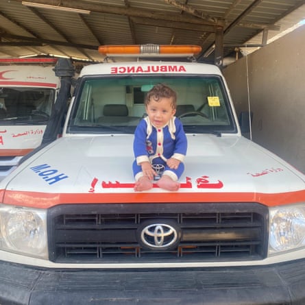 Abed Elrahman Hamdouna’s infant daughter sitting on the bonnet of the ambulance her father drove.