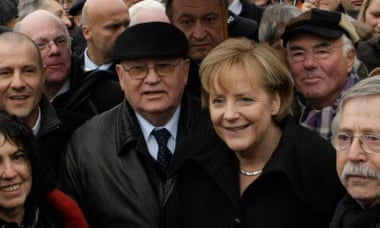 Mikhail Gorbachev and Angela Merkel join a crowd commemorating the 20th anniversary of the fall on the Berlin Wall