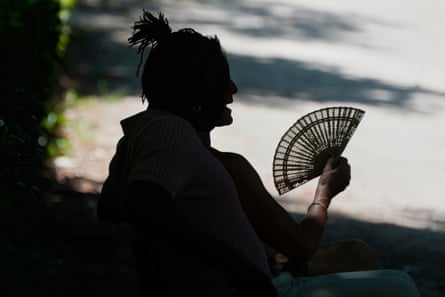A woman takes to the shade the Retiro park in Madrid, Spain.