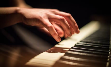 Close up of hands playing piano
