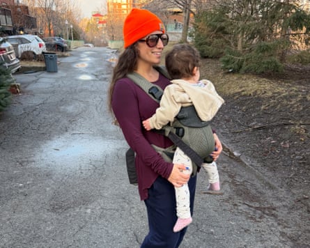 A woman carrying a baby in a BabyBjörn Harmony Baby Carrier