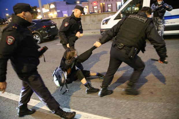 Russian Police officers detain a female protester during an unsanctioned anti-war protest rally at Arbat street in Moscow.