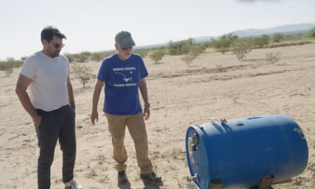 Joel Smith shows Laughland a life-saving water tank patched up after it was shot with bullet holes by rightwing vigilantes.